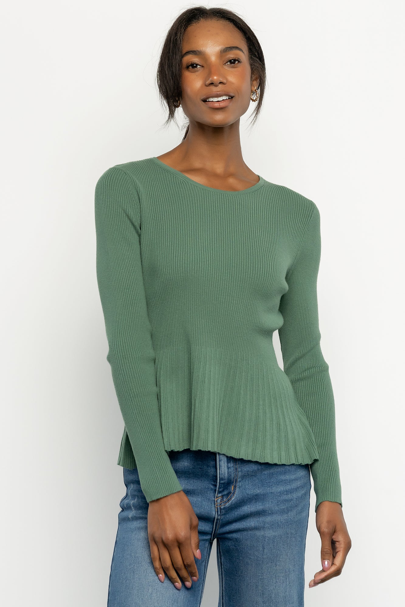 Back view of the ribbed peplum top in winter green showing fit across the shoulders and the raw hem detail at the waist.