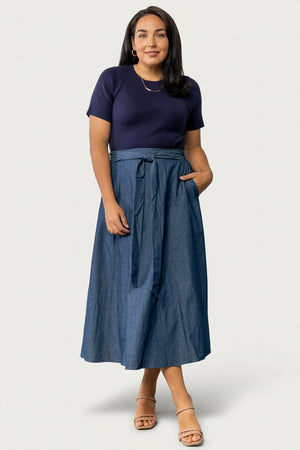 Detail shot of the chambray denim-look skirt fabric and stitching, emphasizing the lightweight, casual texture of the skirt.