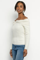 Detail shot of subtle center knot and foldover neckline on the Perla ivory off-shoulder sweater.