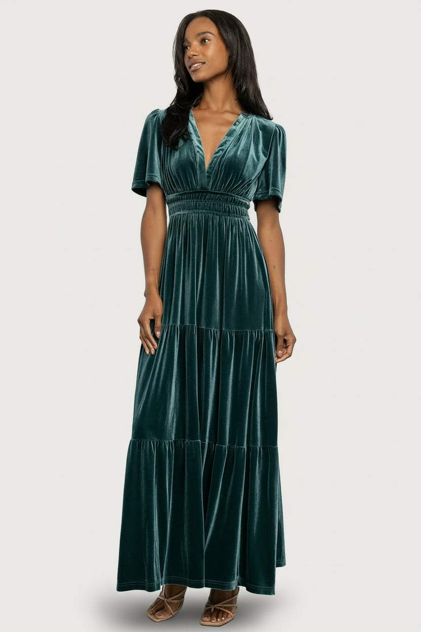 Front view of the Artemis Deep Lagoon velvet maxi dress on a model, showing the plunging V-neck and short flutter sleeves.