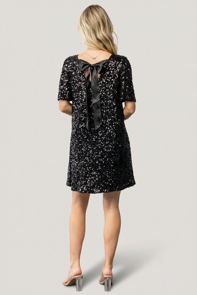 Side view of the shift dress showing hidden side pocket placement and the silhouette of the short party dress in black.