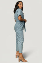 Fabric close-up showing denim-like weave and soft hand of the Mateo jumpsuit's 97% cotton, 3% polyester blend.