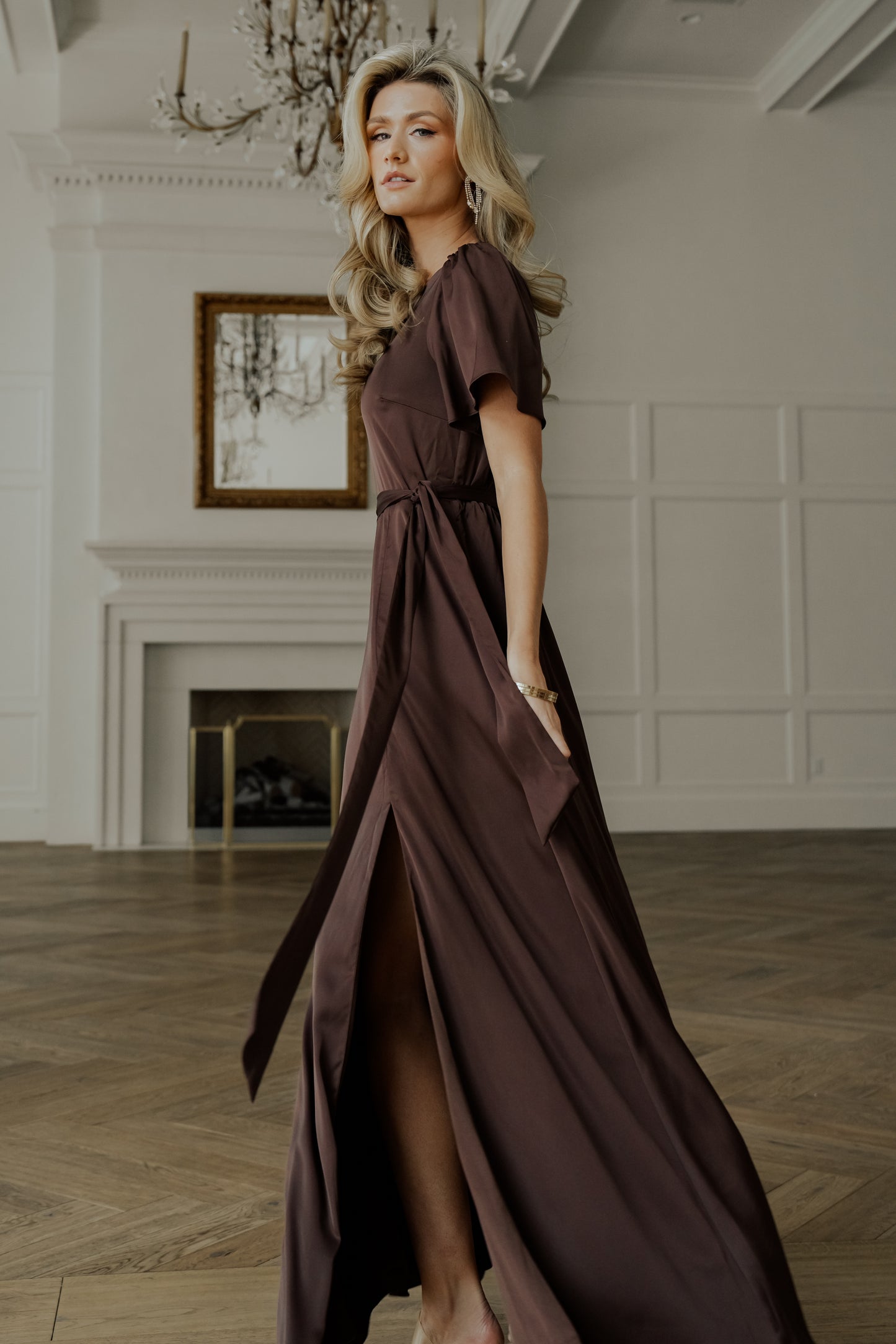 Model shot of the Agnes espresso maxi captured in motion to show skirt movement, slit reveal, and overall silhouette.