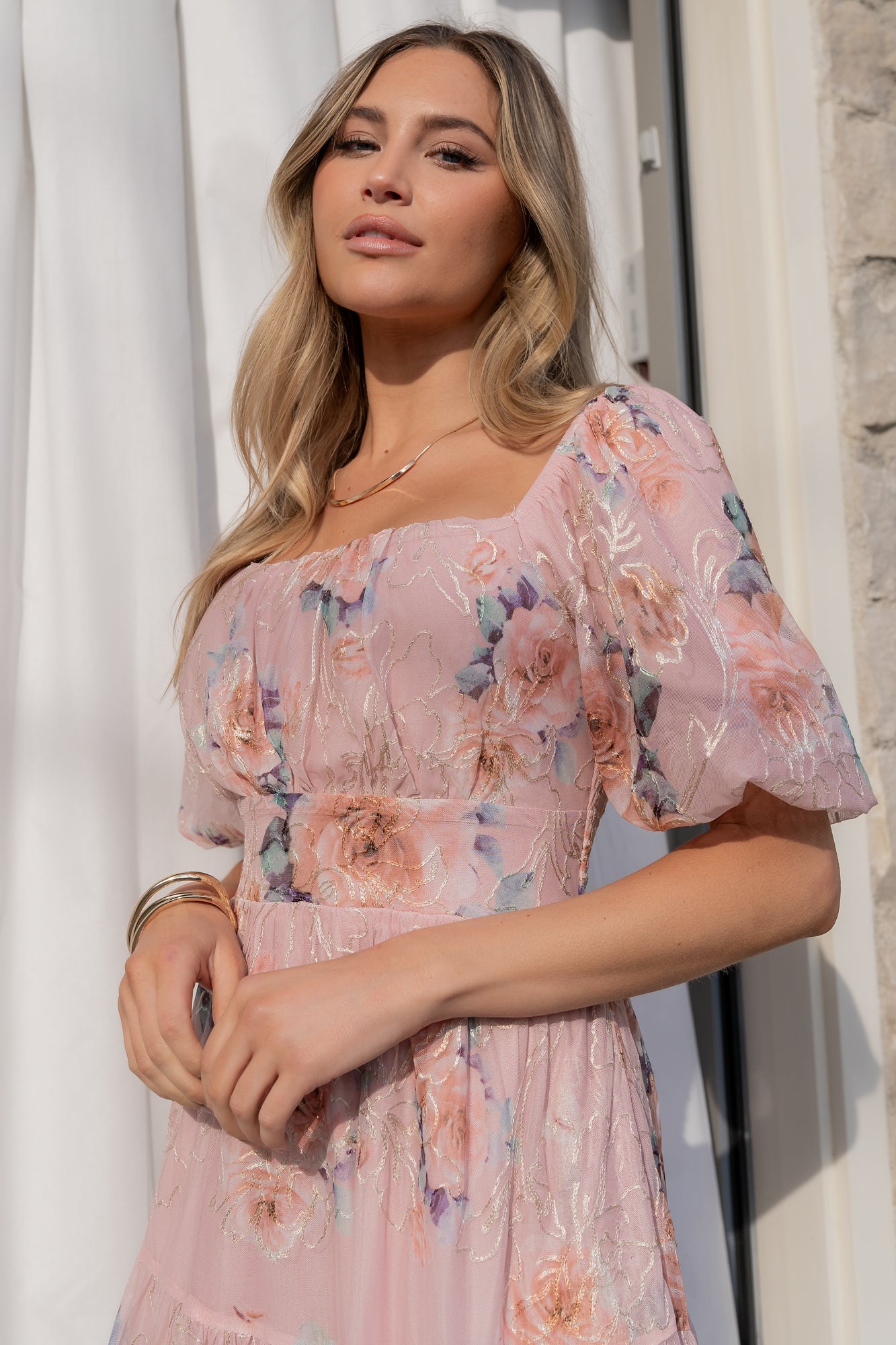 Styled look of Annabeth midi dress in blush floral with delicate embroidery, suitable for photos, showers, and semi-formal events.