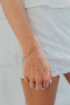 Eloise Link Bracelet photographed in a styled scene to show scale, shine, and how the bracelet layers with other jewelry pieces.