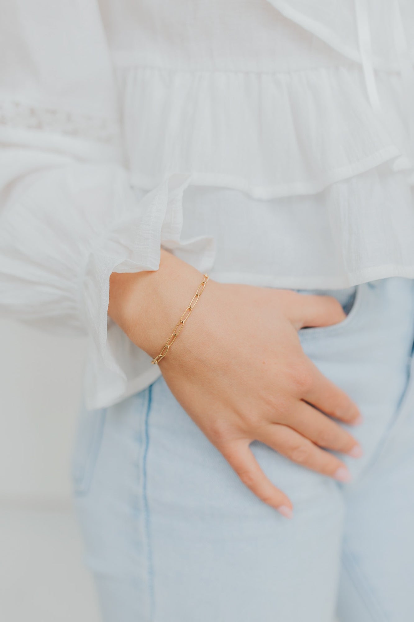 Flat lay of Eloise Link Bracelet displaying the full chain, lobster clasp, and extender; gold-plated links catch the light for subtle shine.