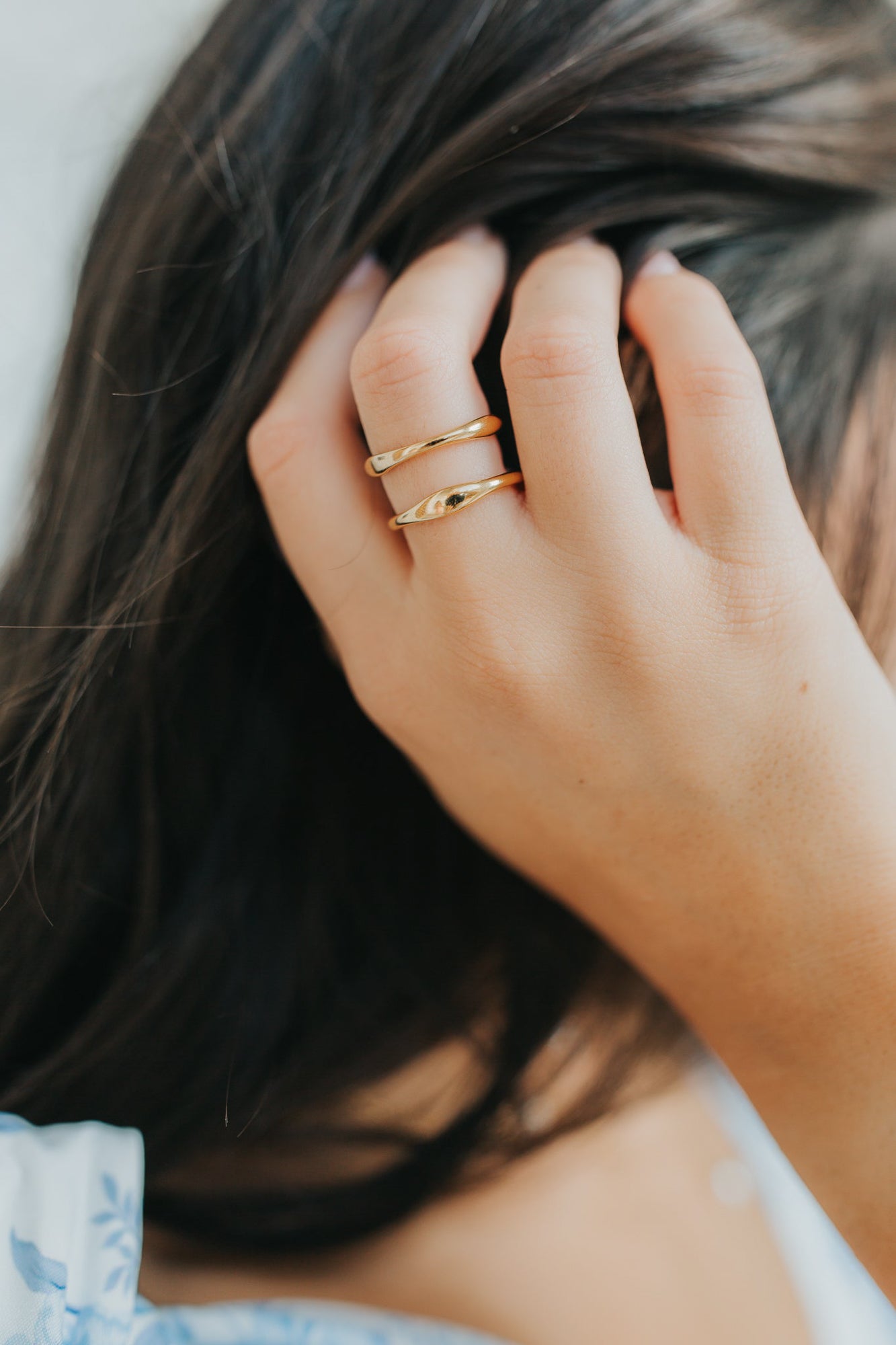 Studio macro of the Florence ring showing the wave-shaped band and gold-plated finish with textured lighting to emphasize profile.