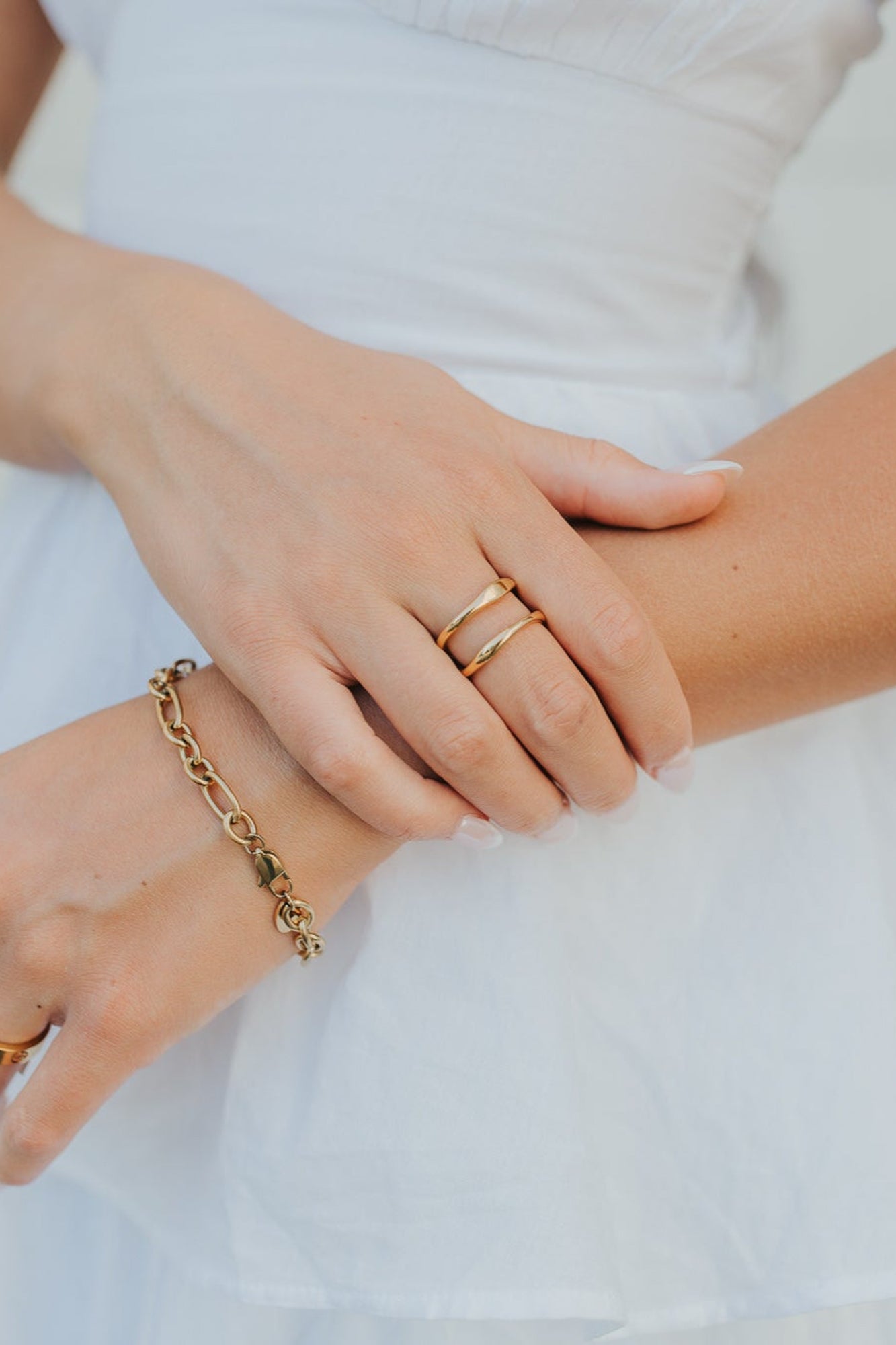 Lifestyle image of the Florence ring paired with a Hannah bracelet on a textured background, showing wearable scale and polished detailing.