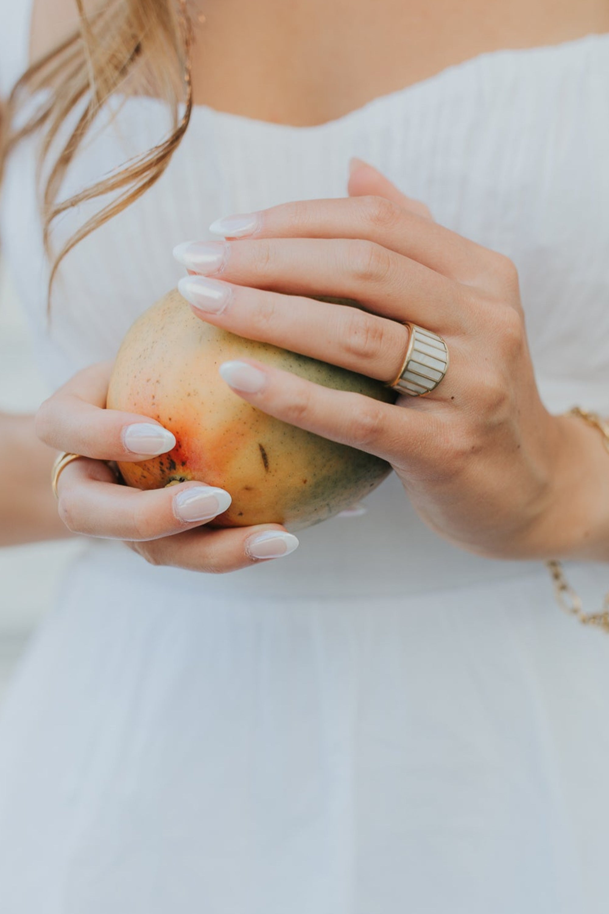 Studio detail image of the Alys ring rotated to display the vertical mother-of-pearl panels and the wide, architectural band silhouette.