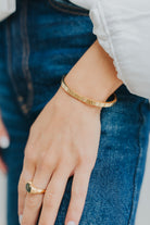 Side profile of the Lily Bracelet highlighting the smooth bevel detailing, high-gloss finish, and the secure hinge/clasp mechanism.