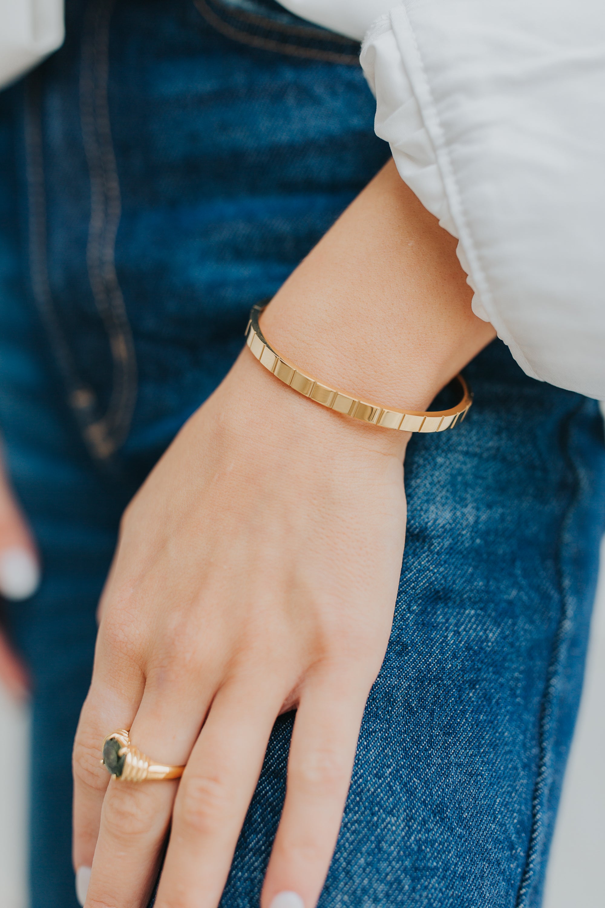 Side profile of the Lily Bracelet highlighting the smooth bevel detailing, high-gloss finish, and the secure hinge/clasp mechanism.