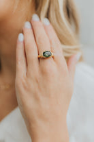 Close-up of the Maddie bezel setting highlighting the secure bezel-style frame and smooth oval-cut emerald stone.