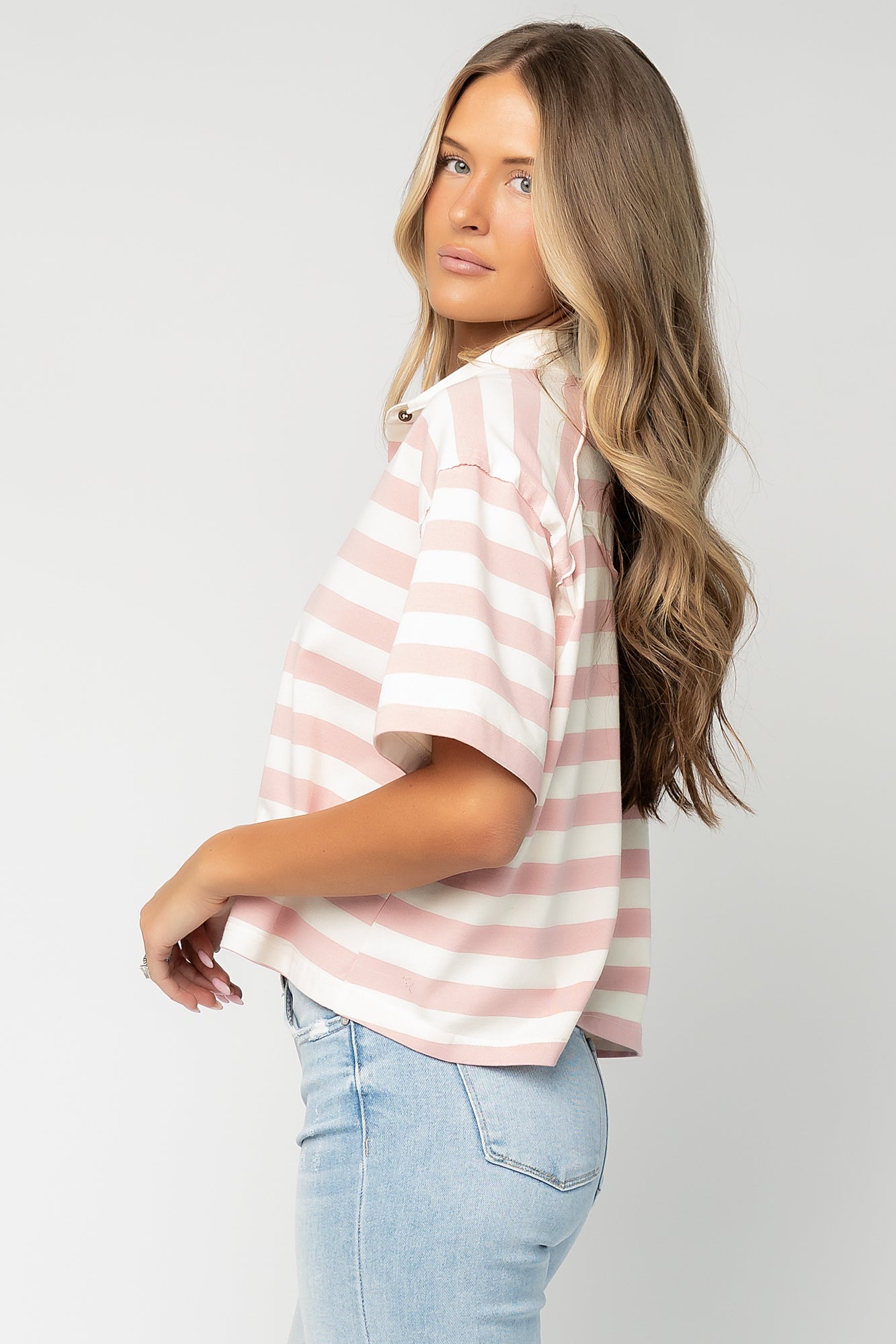 Three-quarter side view of Ruby Striped Top on model showing drape, short sleeve silhouette, and soft midweight fabric.