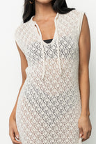Calypso cover-up flat-lay showing unlined construction, crochet-like knit pattern, and subtle rolled hem finish in natural color.