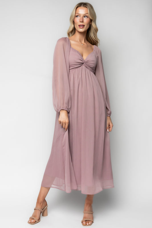 Three-quarter angle of Dione Midi Dress in dusty lilac highlighting puffed sleeve with elastic cuff and empire waistline for a flattering silhouette.