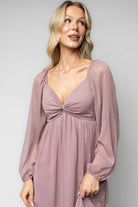 Model wearing Dione Midi Dress in dusty lilac styled with delicate jewelry, illustrating midi length and elegant silhouette for events.