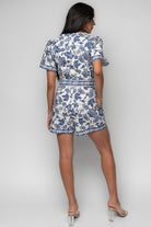 Side view of Rafaela Romper highlighting gathered shoulders on short oversized sleeves and the romper’s relaxed, easy fit through the body.