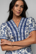 Detail image showing the functional front pockets and concealed pant zipper on the Rafaela Romper’s shorts-style bottom.