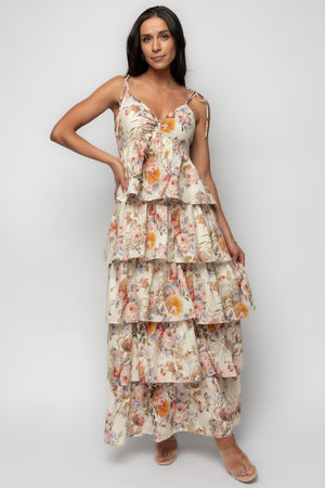 Front view of Angelica Tiered Maxi Dress in buttercream with muted pink, yellow and purple florals; V-neck, twist bust and adjustable tie straps.