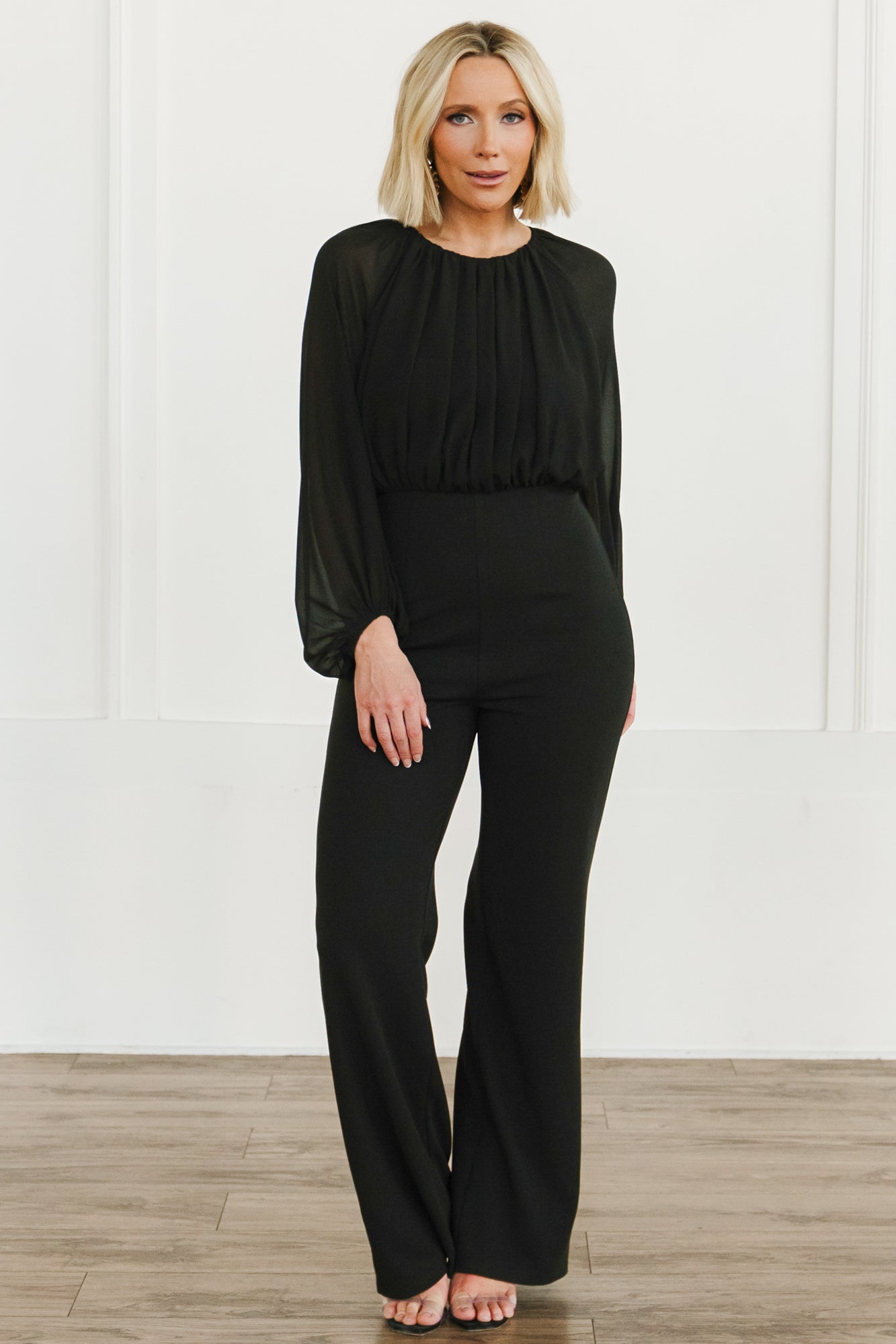 Front view of Serene Blouse Jumpsuit in true black on model, showing chiffon blouse, round neckline, fitted bodice and relaxed straight trousers.