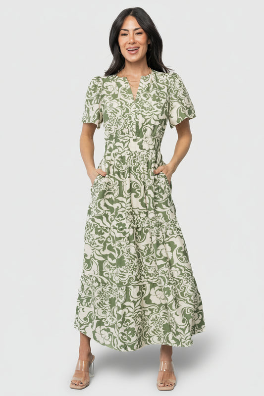 Front view of Aventura Tiered Midi Dress in ivory and green floral print on mannequin, showing V-neck and short gathered sleeves.