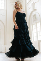 Side view of the Tiana Tiered Maxi Dress in black highlighting the layered ruffle tiers, movement of the chiffon, and smocked back detail.