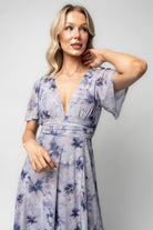 Back view highlighting banded empire waist with elastic back, gentle gathering at the waistline, and the smooth lined skirt silhouette.