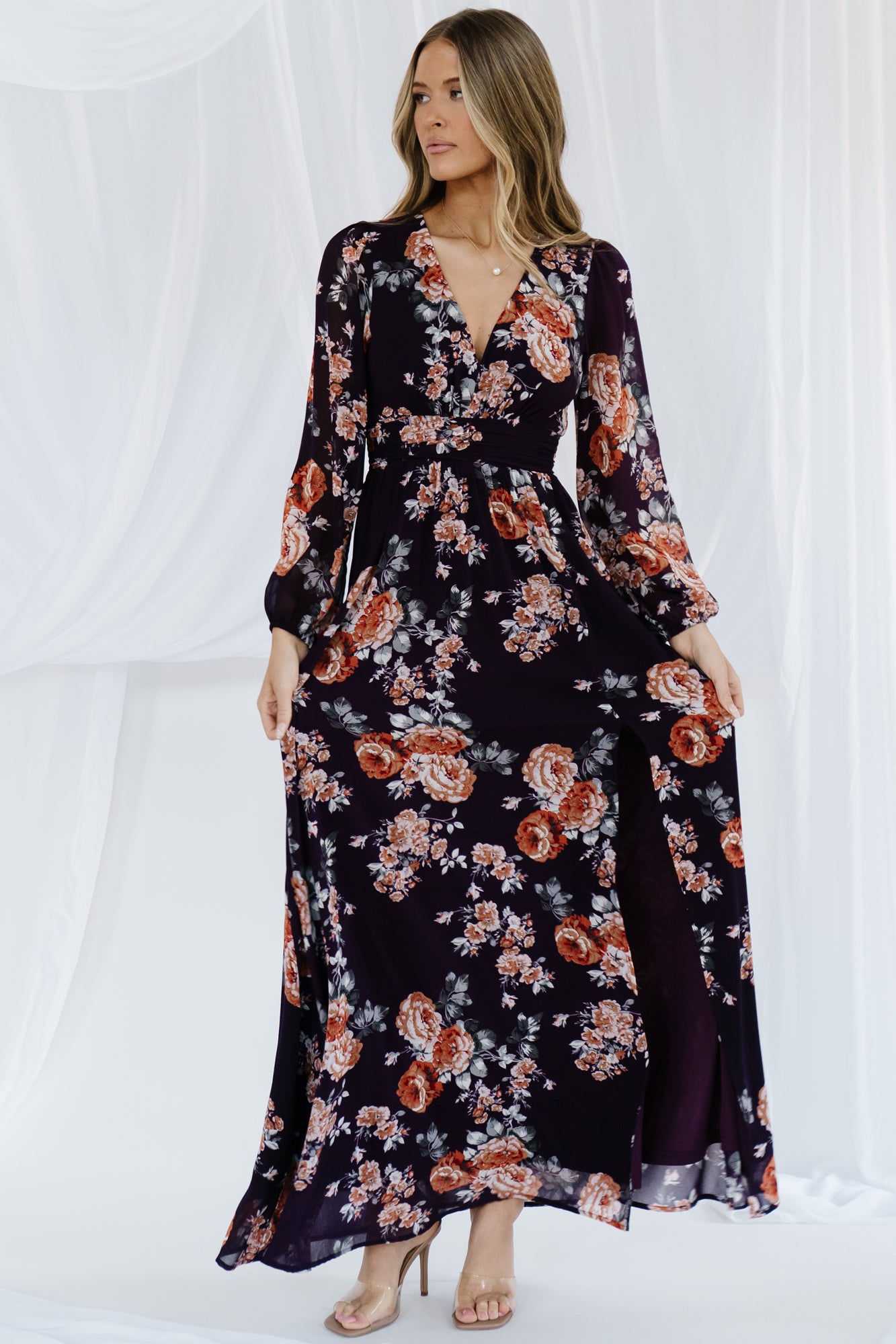 Close-up of front waist gathering and fabric texture on the plum floral maxi, showing construction and feminine shaping at the waist.