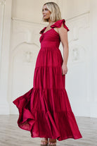 Detail image of the Vivianne Maxi Dress fabric and lining in deep red, showing ruffle tiers and the hemline finish above the lined section.