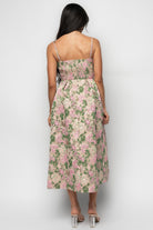 Back view highlighting the back zipper and smocked panel of the Antoinette dress, and how the A-line skirt falls from the pleated waist.