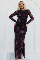 Front view of Isadora Maxi Dress in deep plum floral mesh, showing long sheer sleeves, round neckline and bodycon silhouette with left slit.