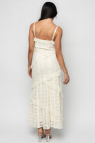 Model wearing Annabelle Lace Maxi Dress in cream styled with sandals, demonstrating length, drape, and movement of the tiered lace skirt.