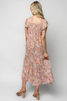 Close-up detail of blush floral print and ruched bust on chiffon Teuila Midi Dress, showing texture, color, and delicate stitching details.