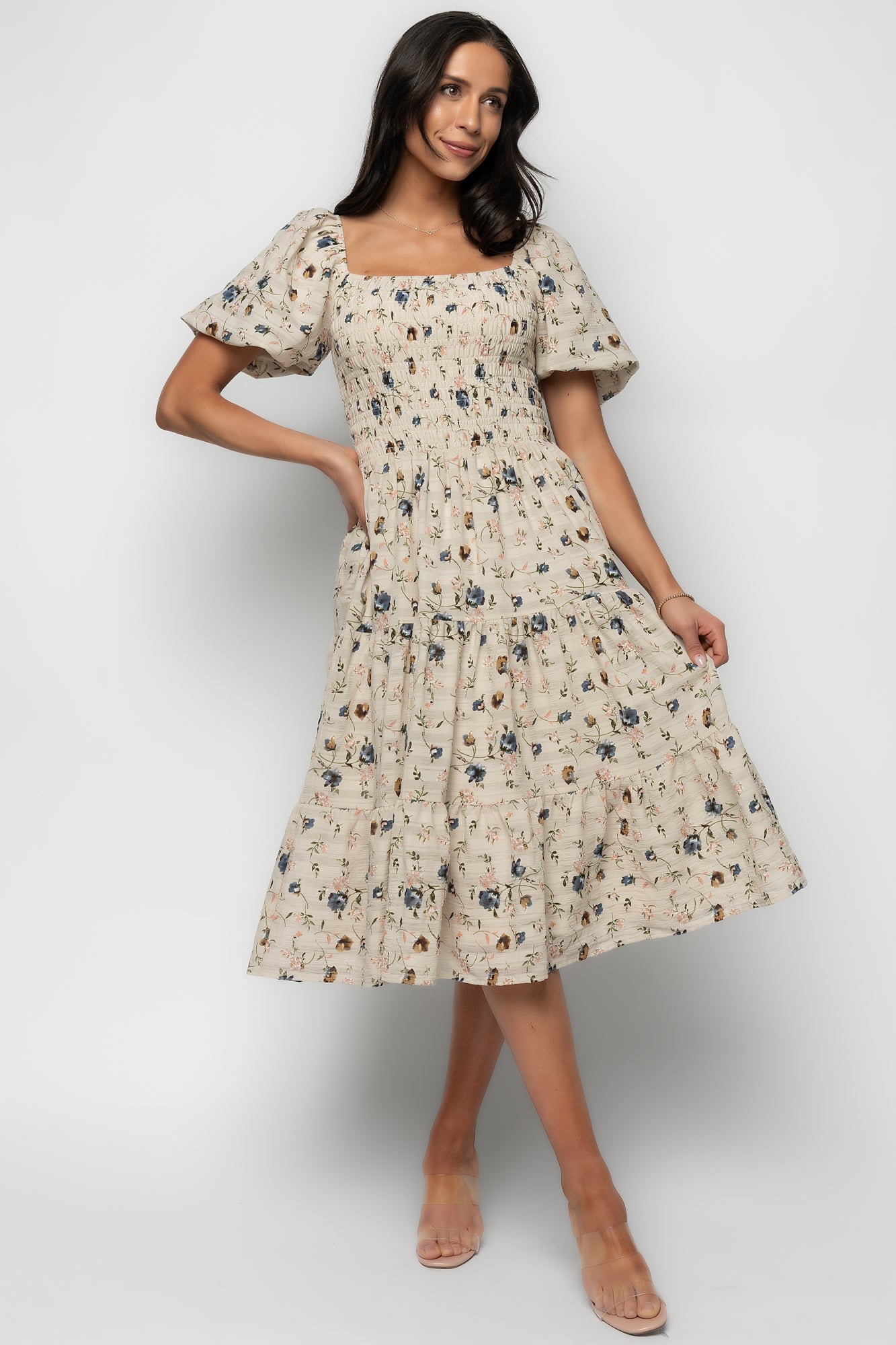 Side profile of beige floral Mattea midi dress highlighting balloon sleeve with elastic shoulder and textured crepe fabric detail.