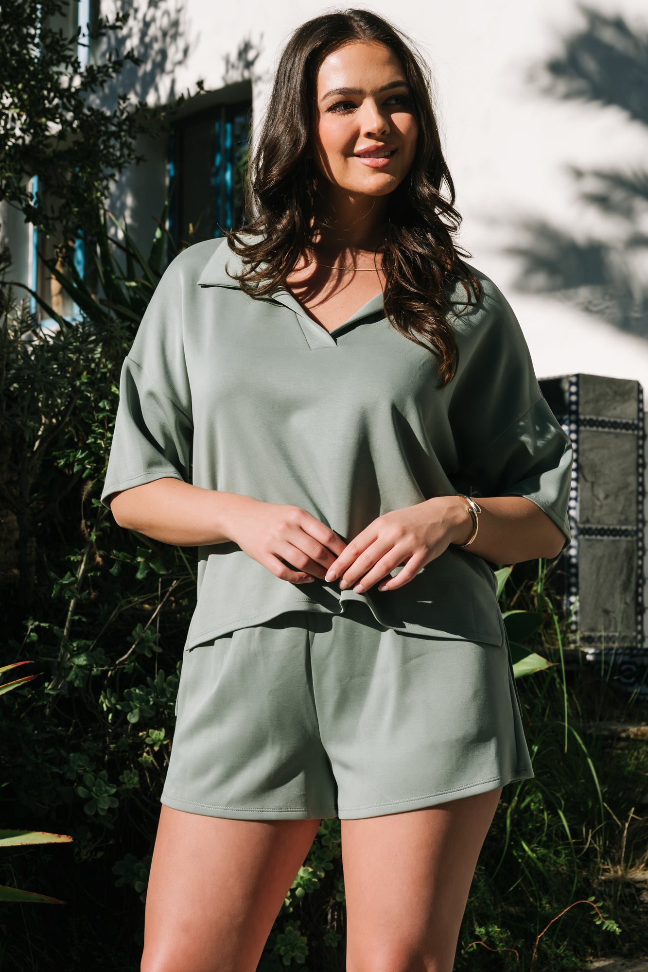 Lifestyle photo of model seated in Ana top and shorts, showcasing unlined construction and comfortable fit.