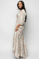 Styled detail image of the Esther Maxi Dress showing the godet hem in motion, demonstrating the dress's flow and full maxi length in sage with blush florals.