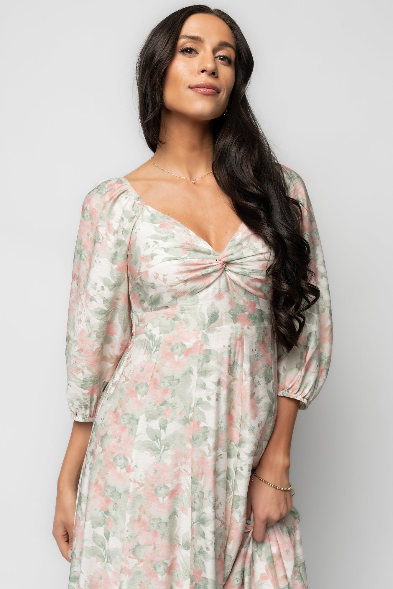 Back view of the Esther Maxi Dress revealing the smocked back panel and how the up-pointed paneled waist shapes the silhouette for a comfortable fit.