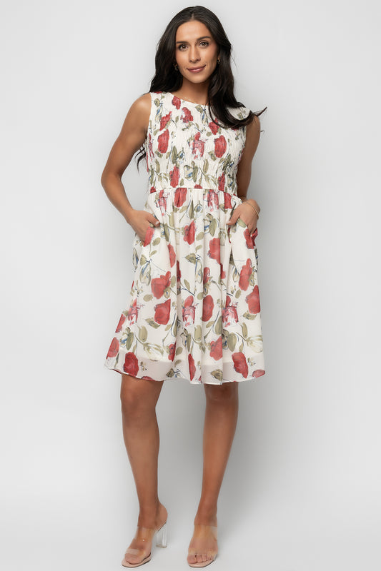 Three-quarter view of the rose floral Clémence dress highlighting smocked bodice, tank sleeves, and fitted waist detail.