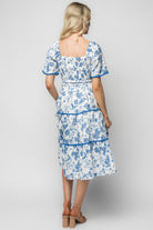 Back and side view of the Freya dress showing puffed elastic sleeves, unlined sleeve detail, and the tiered skirt movement.