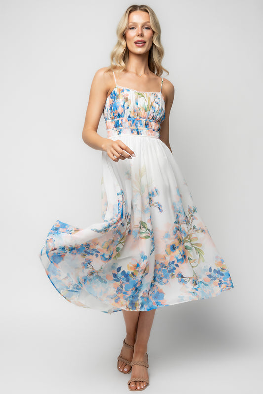 Back view highlighting the smocked back panel and hidden zipper on the white and blue floral Marceline chiffon midi dress to show fit and finish.