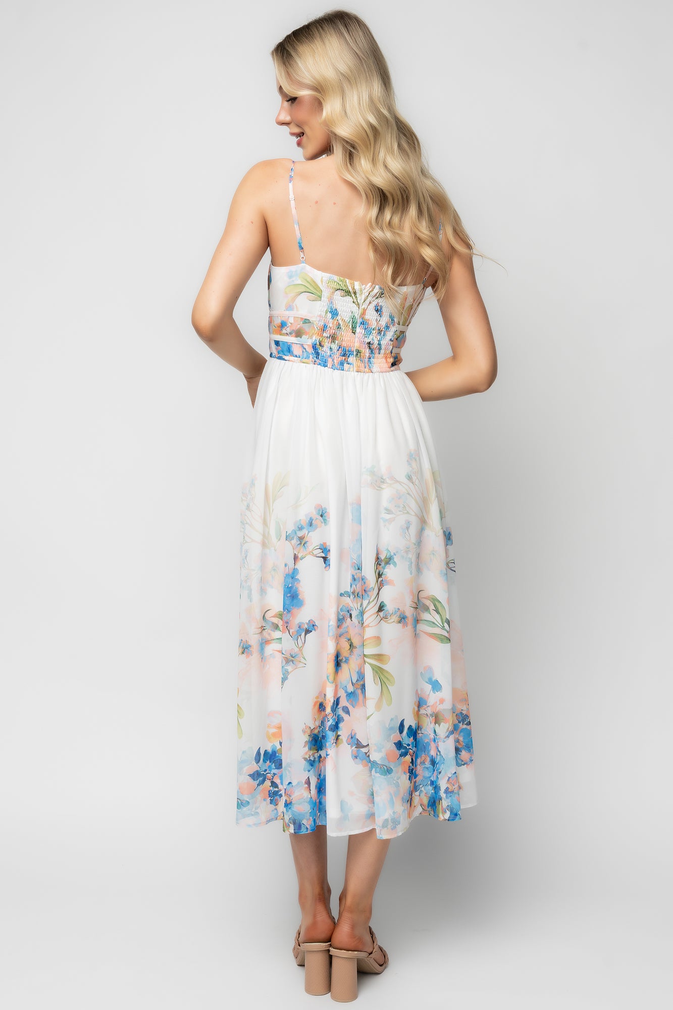 Detail of adjustable tank straps and gathered elastic waist on the white and blue floral Marceline midi dress, showing functional styling.