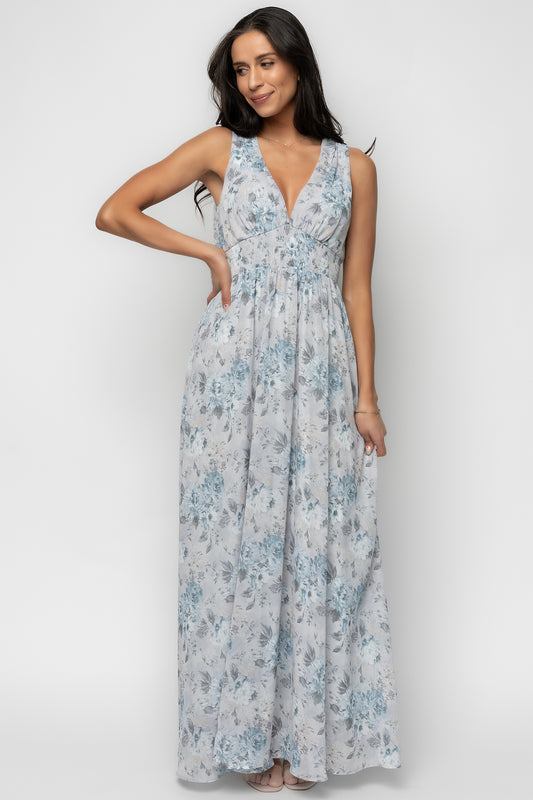 Three-quarter angle of Imogen Maxi Dress showing dusty-blue floral pattern and soft chiffon movement, highlighting smocked waist and bodice shape.