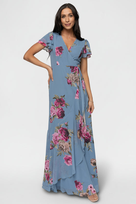 Willa Maxi Dress in slate blue floral on a model, showing short flutter sleeves and soft chiffon drape across the A-line silhouette.