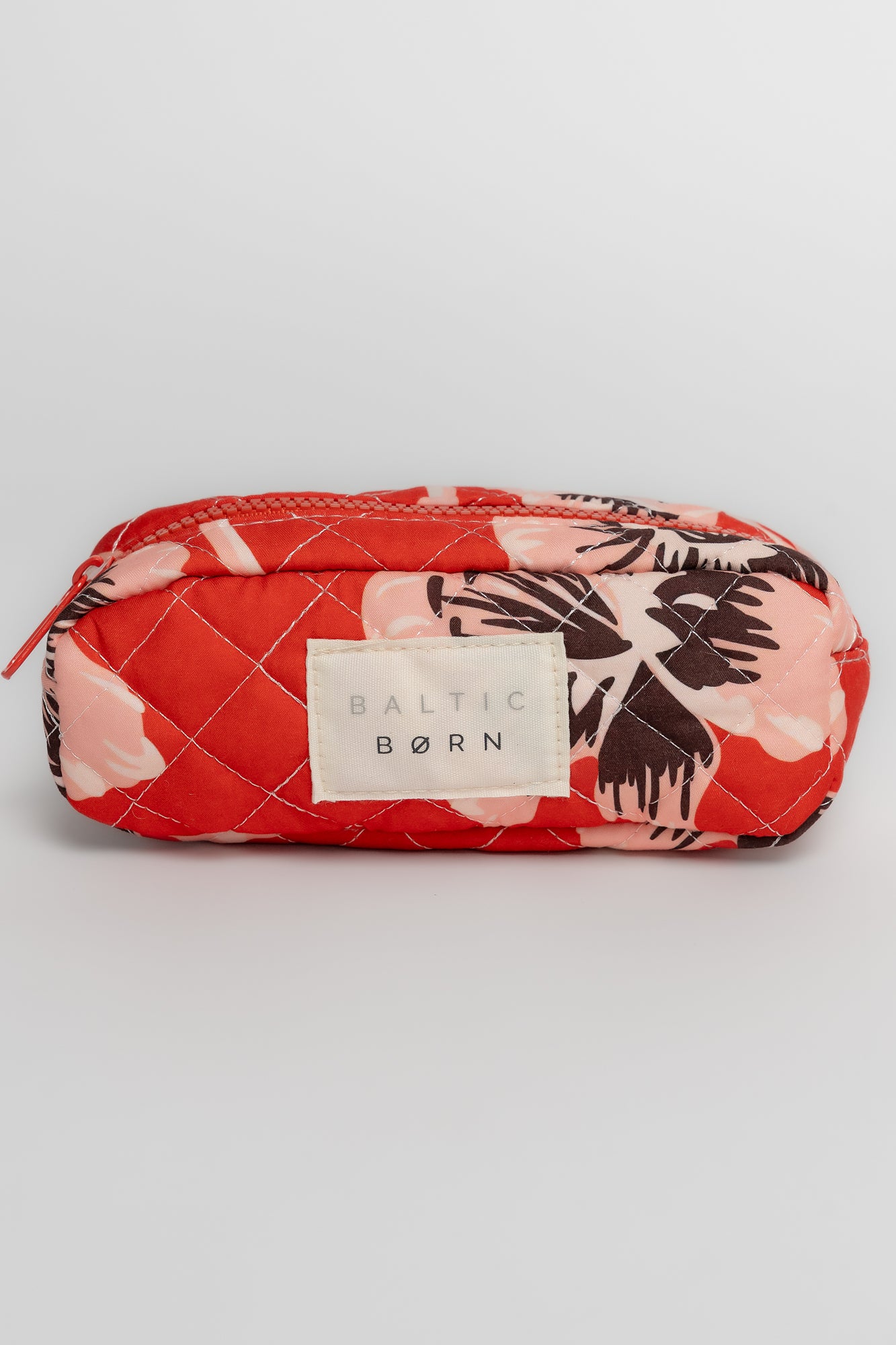Top-down view showing interior opening and full-length zipper of the largest Kelani cosmetic bag in sunset floral print.