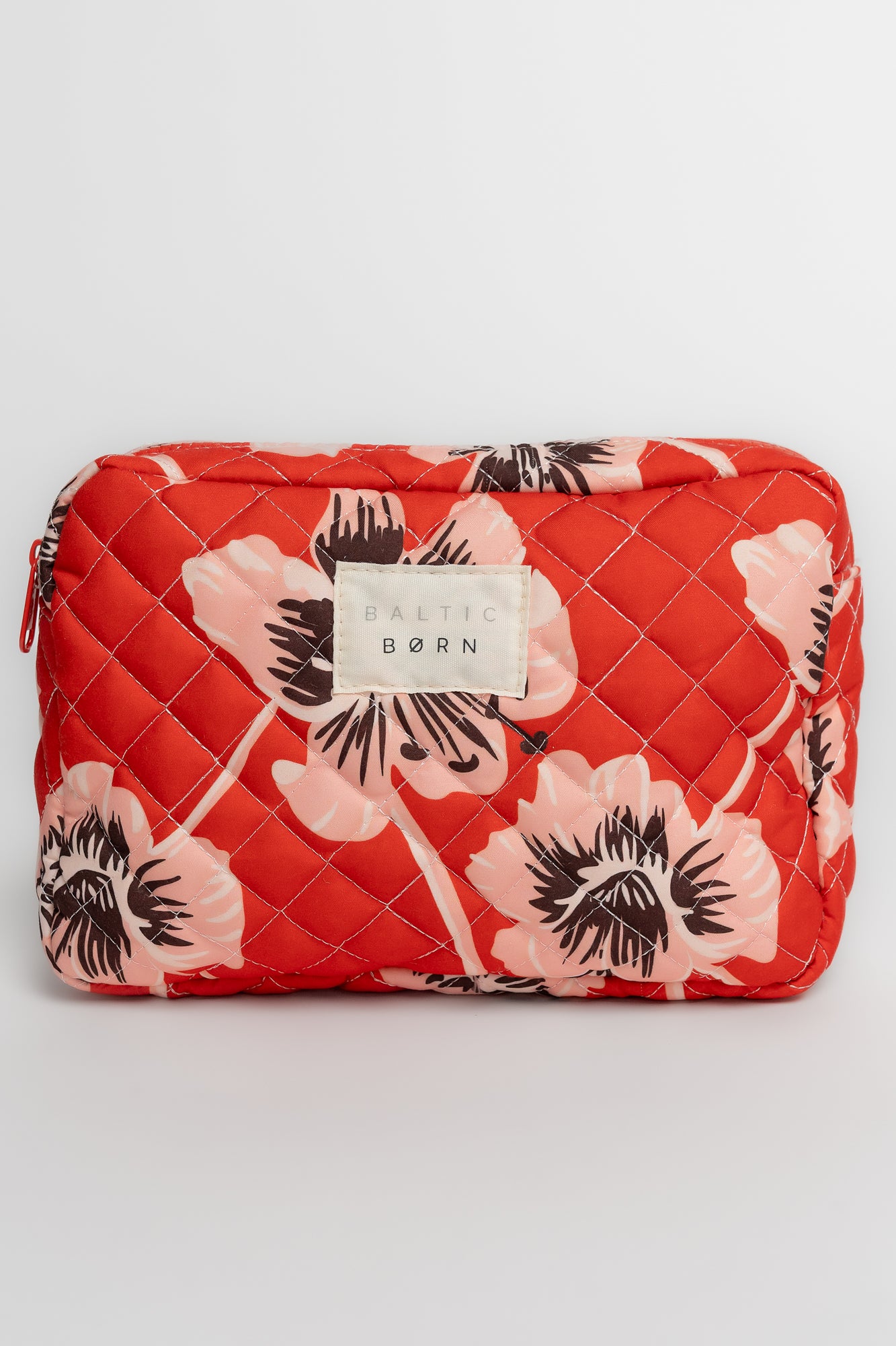 Side view of the three-piece cosmetic bag set showing depth and how the bags stack inside one another for compact storage.