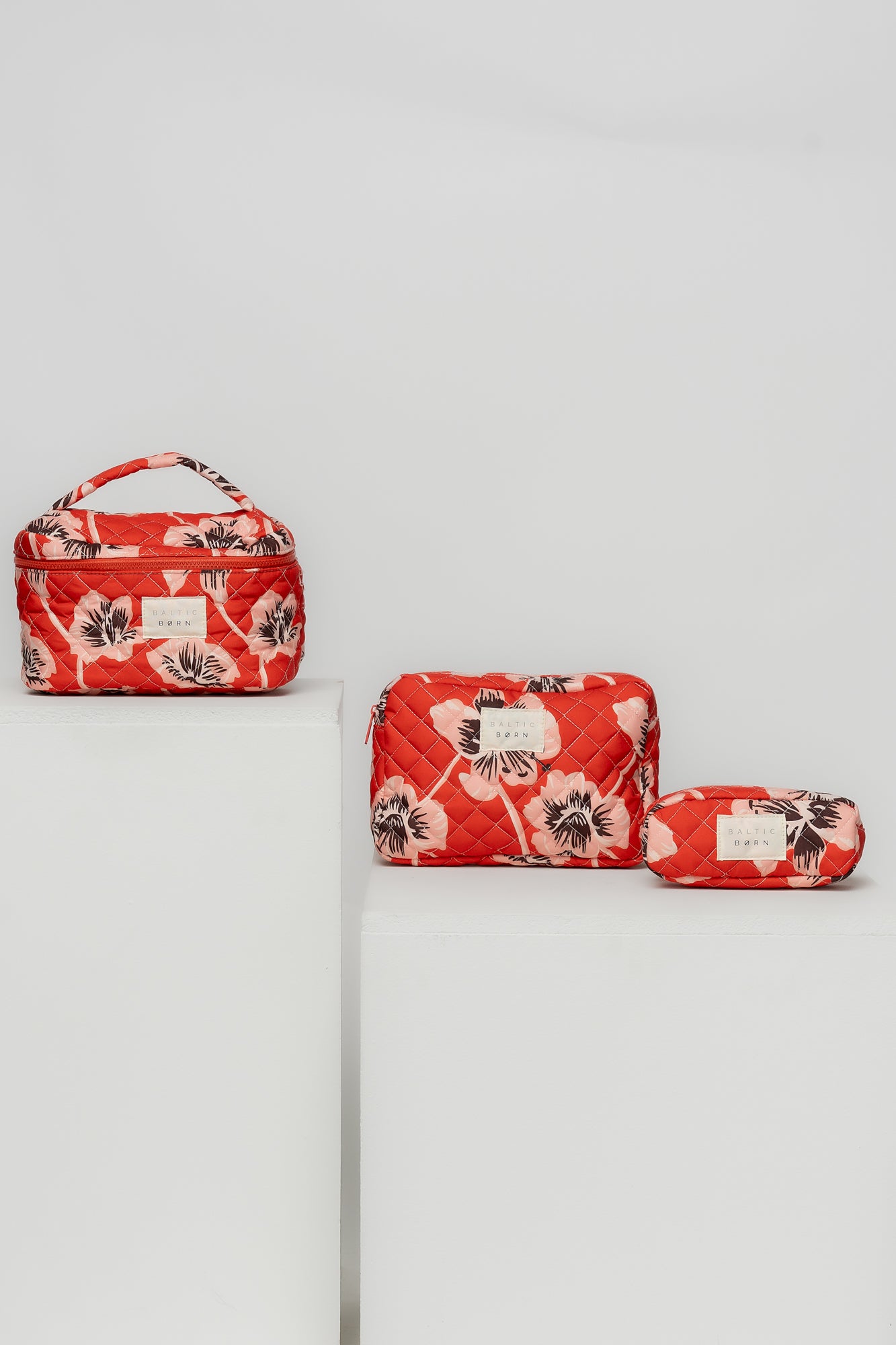 Styled image of the Sunset Floral Kelani bags placed near daily essentials, demonstrating travel and everyday organization use.