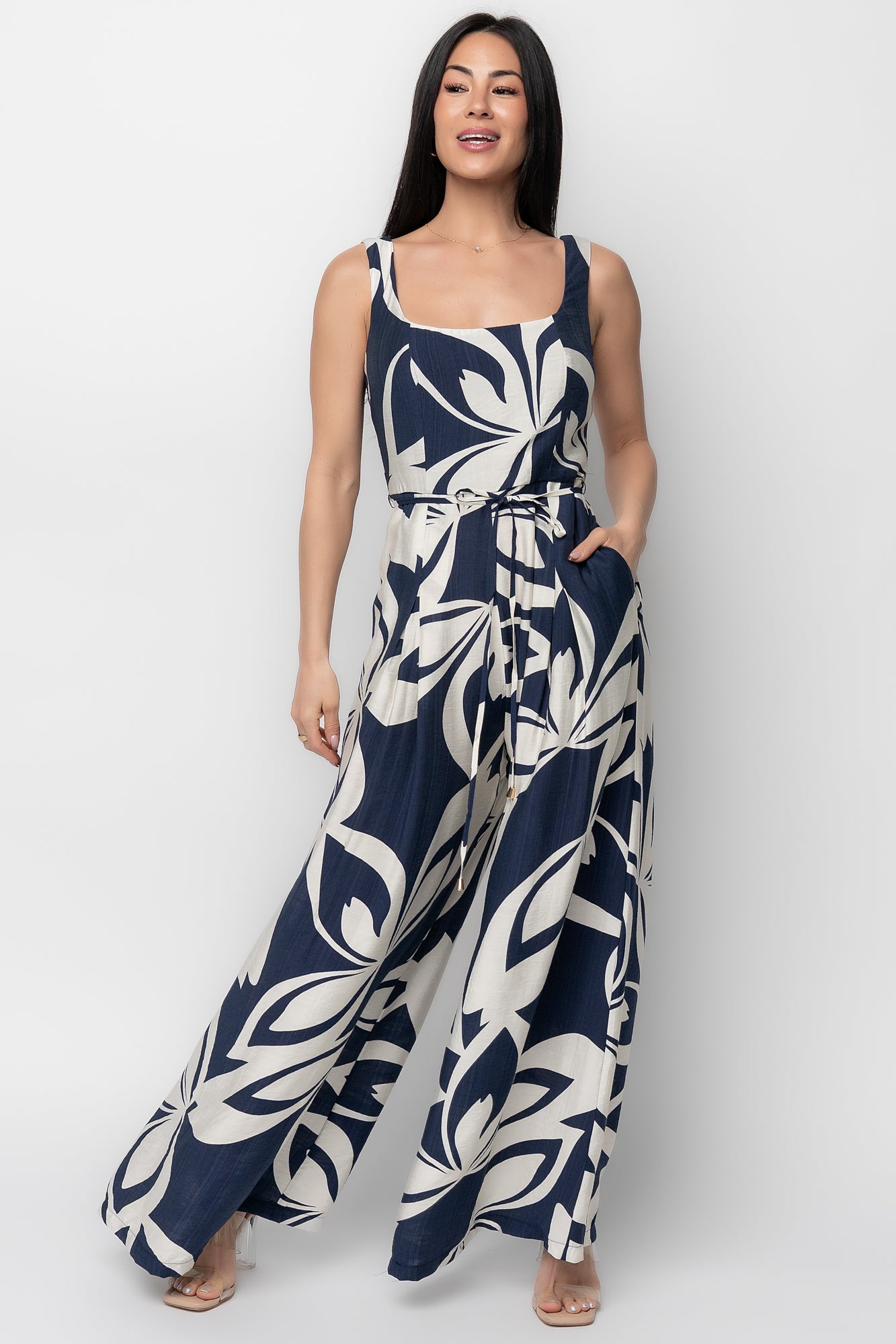 Model styling of Manuela wide-leg jumpsuit in navy abstract print paired with sandals, illustrating versatile day-to-night outfit possibilities.