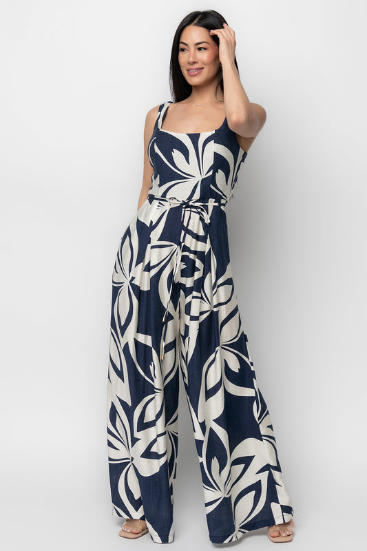 Front view of Manuela wide-leg jumpsuit in navy abstract print on model, showing square neckline, tank sleeves, and removable waist tie for shape.