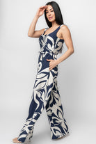 Side view close-up of Manuela jumpsuit in navy print highlighting hidden side pocket, pleat detail, and the lightweight rayon-blend drape.