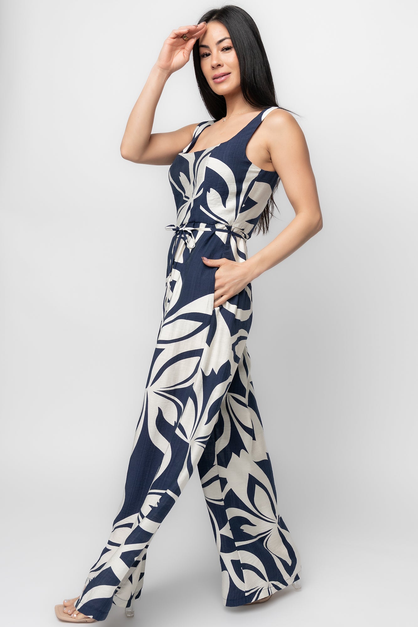 Side view close-up of Manuela jumpsuit in navy print highlighting hidden side pocket, pleat detail, and the lightweight rayon-blend drape.